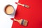 Wooden paint brushes, open paint can on trendy red and white background. Top view, copy space. Appartment renovation