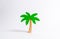 Wooden palm tree on a white background. Tours and cruises to warm countries. The development of tourism. Tropical island.