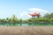 Wooden path with Chinese gazebo building with pond and trees
