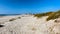 Wooden path at Costa Nova d\'Aveiro, Portugal, over sand dunes with ocean view, summer evening. Wooden footbridge of Costa Nova