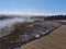 Wooden path leading through geothermal area Geysir, Haukadalur, Iceland, Golden Circle, with hot springs and fumaroles.