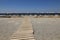 Wooden path to the sandy beach, Greece