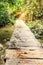 Wooden pathway over waterfall in forest