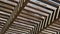 A wooden patio cover with sunlight showing an abstract pattern of light.