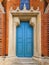 Wooden patterned castle doors. Part of the castle with doors and brick walls