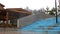 Wooden pavilion in raining season located near concrete stairs on grey heavy sky background. Stock footage. Covered