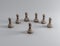 A wooden pawn is facing several other pawns with the same color, 3d illustration