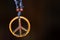 Wooden peace symbol attached to string necklace fairies love not