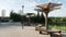 Wooden pergola in a city recreation park with a lake in the residential area