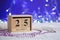 Wooden perpetual calendar set on 25 of December with Christmas d