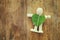 wooden person holding a heart shaped leaf. ecology and recycling concept.