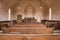 Wooden pews inside rustic wooden church