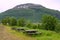 Wooden picnic table against Norwegian landscape