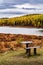 Wooden picnic table and bench on the shore of Lake Kidelu