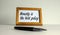 Wooden picture frame with inscription `honesty is the best policy` on beautiful white fon. Pen on the table