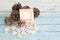 Wooden picture frame placed on a vintage wooden table with Brown Pinecone or Conifer cone and wooden heart decoration