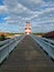 Wooden picturesque bridge to the lighthouse, red-white lighthouse, moving forward to the goal, Rheinsberg