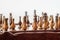 Wooden pieces on chess board. Beginning of game, selective focus. Team strength, success concept