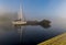 Wooden pier and anchored sailboats