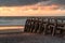 Wooden pier at the beach in Normandy at sunset