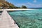 Wooden pier and beautiful reef upon arrival in kanawa island