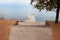 Wooden pier with benches with tree and stone road on beach to sea. Rest, travel, tranquility, sunset and sunrise