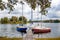 Wooden pier dock with boats yachts on the lake, fishing, summer