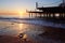 Wooden pier on a fancy orange sunset.