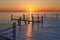 Wooden pier on a fancy orange sunset.