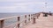 A wooden pier with fishermen spending the summer evening immersed in their hobby