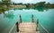 Wooden Pier on Green Blue Lagoon, Tropical Paradise. Traditional Bamboo Pier or Jetty on Lakeside. Concept of New Beginning of Exp