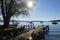 wooden pier on island Fraueninsel on lake Chiemsee with the Alps in the background, Bavaria on a sunny day in May