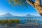 Wooden pier at Lake Atitlan on the shore at Panajachel, Guatemala.  With beautiful landscape scenery of volcanoes Toliman, Atitlan