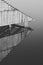Wooden pier of Lake Mjosa in the town of Kapp, Norway, under a cloudy sky, in grayscale