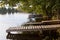 Wooden pier on the lake side view with green trees. summer day