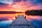 Wooden pier on the lake at sunset. Beautiful summer landscape, Small boat dock and beautiful sunset landscape view with a huge