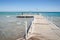 Wooden pier leading to the sea on a sunny day/beautiful wooden pier leading to the sea with blue sky