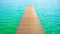 Wooden Pier Leading To Turquoise Waters