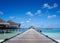 Wooden pier leading water bar on indian ocean in the Maldives.