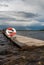 Wooden pier with a lifeline against a background of gray clouds