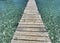 Wooden pier in the middle of turquoise sea water