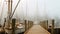 Wooden pier in the misty morning. Yachts and boats, AI Generated