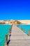 Wooden Pier at Orange Bay Beach with crystal clear azure water and white beach - paradise coastline of Giftun island, Mahmya,