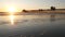 Wooden pier on piles, silhouette at sunset, California USA, Oceanside. Sunny sea waves at sundown.