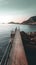 A wooden pier stretching out into the sea, surrounded by rocks