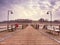 Wooden pier in summer holiday destination. Late summer landscape with cloudy sky