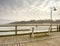 Wooden pier in summer holiday destination. Late summer landscape with cloudy sky