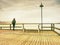 Wooden pier in summer holiday destination. Late summer landscape with cloudy sky