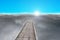 Wooden pier with sunrise, dark clouds and blue sky