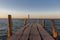 Wooden pier at the sunset. Evening sky over sea with footbridge. Calm evening landscape. Empty pier at seaside with copy scape.